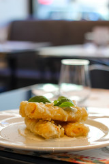 fried cannelloni stuffed with mozzarella with basil, cream cheese and pepper, italian restaurant