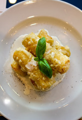 fried cannelloni stuffed with mozzarella with basil, cream cheese and pepper, italian restaurant