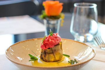 dish with roasted artichoke, fassona meat and potato mousse, in a luxury Italian restaurant