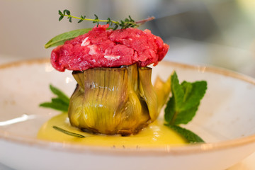 closeup of dish with roasted artichoke, fassona meat and potato mousse, in a luxury Italian restaurant - 309275813