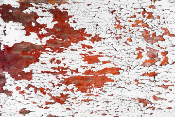 Red old wooden texture background. Weathered wooden board with peeled off white paint. Close up, copy space