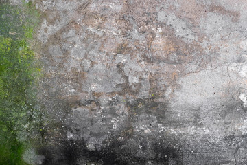 Abstract grunge texture of old colorful wall with cracks and scratches. Creative background. Green, grey and black rough weathered stone texture with moss, stucco and paint. Copy space