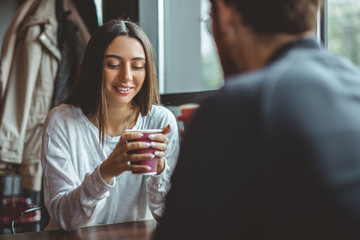 Young female enjoying beverage during date