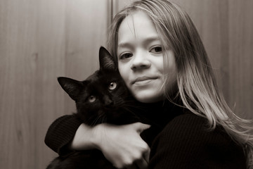 Black and white photo of a girl with a cat