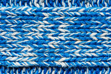 The texture of a knitted blue white sweater. Beautiful textured arana patterns. Background. Copy space