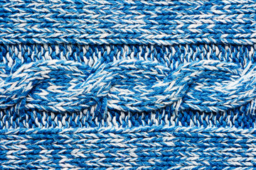 The texture of a knitted blue white sweater. Beautiful textured arana patterns. Background. Copy space