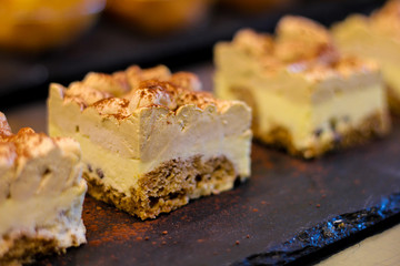 row of dessert pastries with ice cream and puff pastry and cocoa in traditional Italian pastry