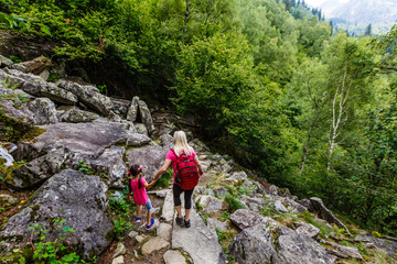 Naklejka na ściany i meble Family Walking Hiking Trail In Mountains In Summer