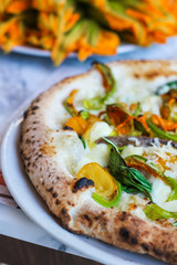detail of a pizza with zucchini flowers, fresh mozzarella cetara anchovies, parmesan cheese and yellow tomatoes of Vesuvius - 309277676