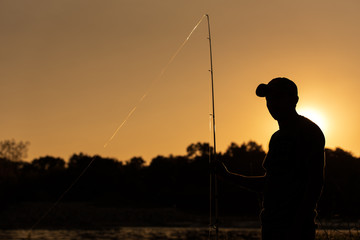 A fisher stands at his fishing spot on the White River in Indianapolis