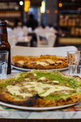 gourmet pizza prepared with broccoli cream, casertano black pig sausage, Agerola provola and a...