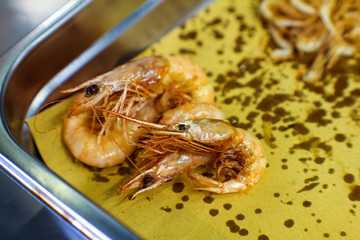 freshly fried shrimp to drain on paper in a professional Italian kitchen