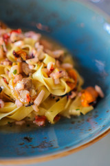 detail of tagliolini with seafood in a refined Italian restaurant