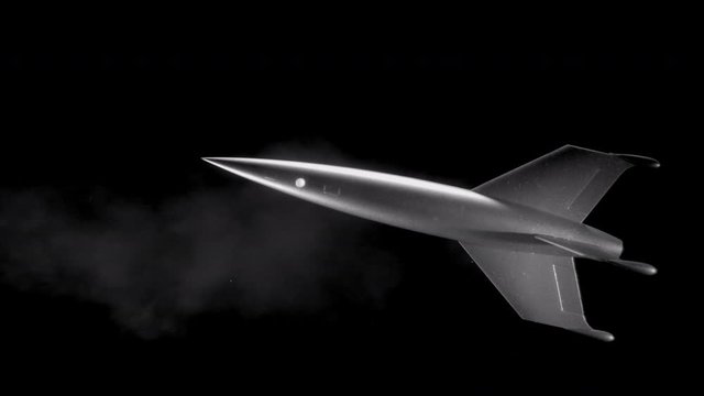 Retro, classic-looking rocket ship travels through outer space.  Black and white 4K, 10 bit.