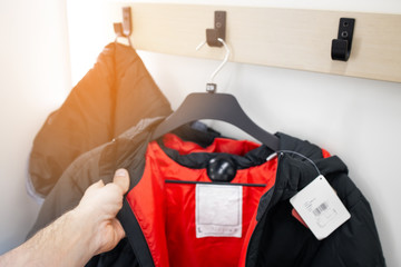Dressing room in shop. Sports clothes on a hangerl. Try on and choose clothes. Sale in shop. Concept of retail. © Anton Gepolov