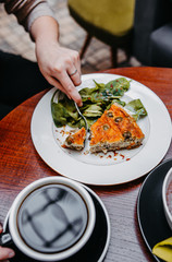 Opened pie with spinach and olives.