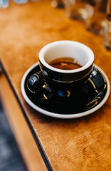 Cup of espresso. Hot fresh coffee drink in black cup. 