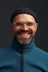 Portrait of a charismatic young man in a hat and glasses.