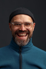 Portrait of a charismatic young man in a hat and glasses.