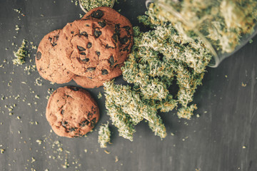 Cookies with cannabis and buds of marijuana hemp Macro of cannabis buds marijuana with trichomes...