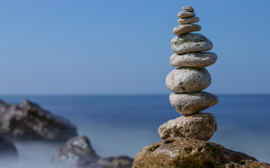 Fototapeta na wymiar Object of stones on the background of the night sky and the sea. Zen stones. Harmony & Meditation