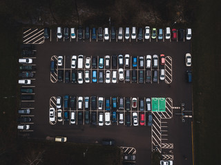 A lot of cars in the parking lot. Colorful moody drone shoot.