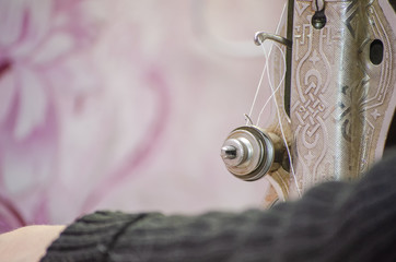 presser foot lift lever, thread tension regulator in sewing machine close-up