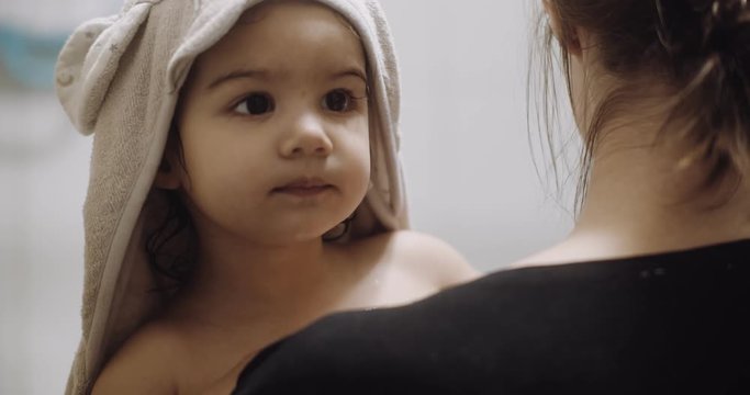Portrait of cute toddler girl doing her after bath routine. Shot in 4K RAW on a cinema camera.