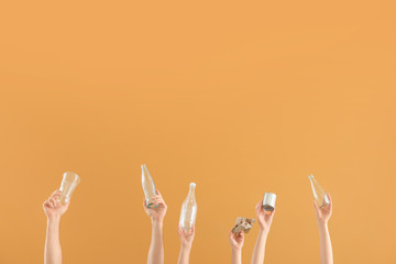 Hands with garbage on color background. Concept of recycling