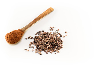Raw cocoa nibs and powdered cocoa side by side, isolated on white