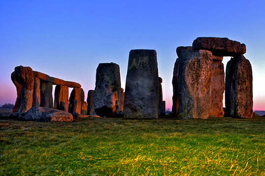 Prehistoric Stonehenge at sunset with strobe illuminating foreground to add depth, Wiltshire, England 