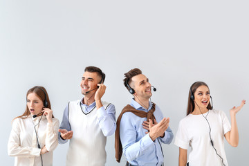 Team of technical support agents on light background