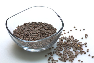 A transparent bowl of lentils on white background