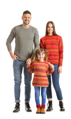 Happy family in winter clothes on white background