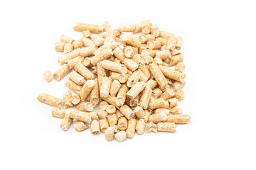 Close up compressed wood pellets for use as an eco-friendly renewable organic biofuel over a white background. Eco-friendly renewable fuel concept
