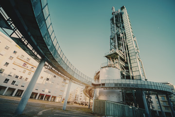 Fototapeta na wymiar A wide-angle view of a modern oil refinery or a contemporary fuel factory facility in an industrial zone: round bridge, pipes, beams, tanks, an auxiliary building around