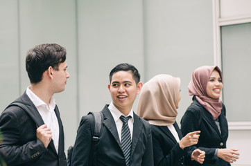 young and confident business people walking together in a modern office corridor