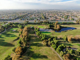 Fototapeta na wymiar Aerial view over golf field. Large and green turf golf course in South California. USA