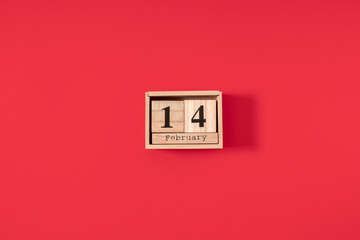 Valentines Day minimum background. February 14 date wooden block calendar  on red background. Flat...