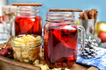 Mason jar of tasty mulled wine on wooden board