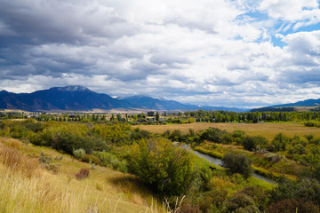 Fototapeta na wymiar The southeastern portion of Idaho provide some amazing scenery. You have the snow topped mountains, the valley covered in autumn colors, and the meandering river. If you look closely, you'll also see 