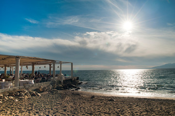 Chair by the sea overlooking the sky and beautiful sea in the background bright sun beach and sand, spa malaga city