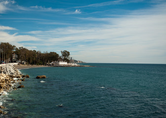Fototapeta premium beautiful photo of malaga city beaches with a spa in the background and trees, palm trees