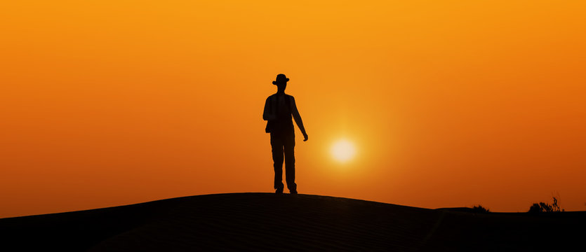 desert photographer black silhouette body in the evening sun
