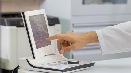 Ophthalmology treatment - a doctor working with a special equipment for checking the visual acuity - tapping on the screen