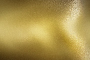 Glowing gold foil glitter metal sheet, abstract texture background