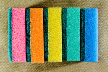 Multi-colored sponges in a row. Microfiber material. For dish washing.