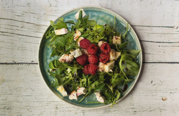 Wild vegetable salad with raspberries and goat cheese
