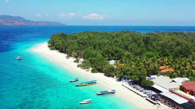 Tropical white sand beach, hotels near the blue lagoon and corall reef. aerial view, Philippines. Seascape with beach on tropical island. Summer and travel vacation concept.