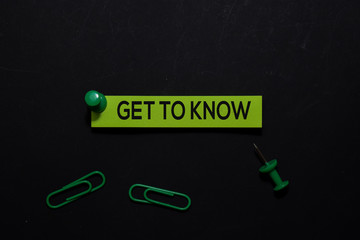 Get To Know write on Sticky Notes. Top view isolated on black background.
